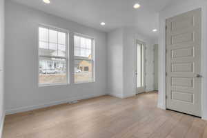 Empty room with recessed lighting and light wood finished floors