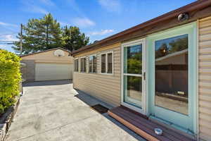 View of property exterior featuring an outbuilding and a garage