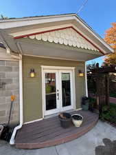View of exterior entry featuring a wooden deck
