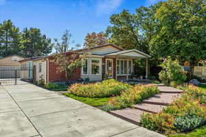 View of front of home with brick siding and a garage