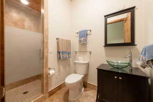 Full bathroom with a shower stall, vanity, and tile patterned flooring