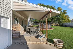 Fenced backyard with a patio and outdoor dining area