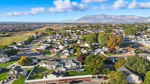Aerial view of property and surrounding area with nearby suburban area
