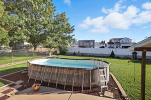 View of pool with a patio area, a residential view, and a fenced backyard