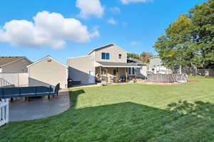 Rear view of house with a patio area landscaped yard