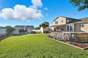 Fenced backyard featuring a patio area and an outdoor pool