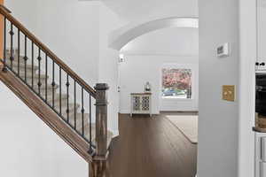 Living Room with arched walkway and vaulted ceilings