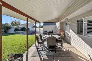 View of patio / terrace featuring outdoor dining area, an outbuilding, and grilling area