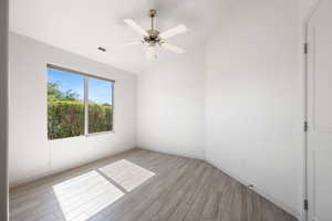 Unfurnished room with vaulted ceiling, wood tiled floors, and ceiling fan