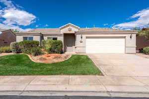 Single story home with stucco siding, a tile roof, concrete driveway, an attached garage, and a front lawn
