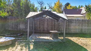 Fenced backyard featuring a gazebo