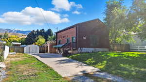 View of front of home with a shed