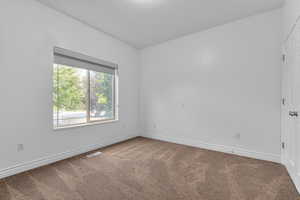 Unfurnished room with carpet and baseboards