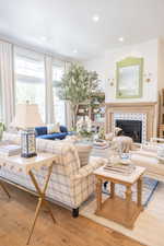 Living area featuring a fireplace, light wood-type flooring, and recessed lighting