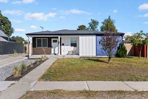 View of front of home with covered porch and board and batten siding