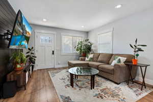 Living room featuring vinyl floors, recessed lighting, and healthy amount of natural light