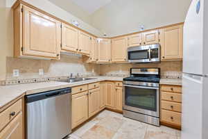 Kitchen featuring light brown cabinets and stainless steel appliances