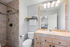 Full bath featuring vanity, a stall shower, and a textured ceiling