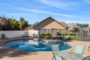 View of swimming pool with a patio and a mountain view