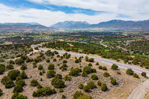 View of rural area featuring a mountain backdrop and a desert landscape