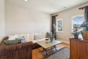 Second floor living room or office with solid wood floors and picture windows