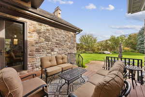 View of patio / terrace featuring an outdoor hangout area and a deck with mountain view