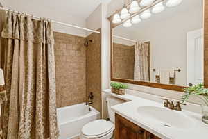 Full bathroom featuring shower / bath combo, located in basement