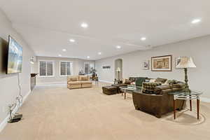 Downstairs rec room / living area with arched walkways, stairs, recessed lighting, and wet bar with two wine coolers, and bread warming drawer
