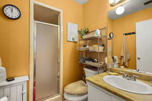Bathroom featuring a shower stall and vanity