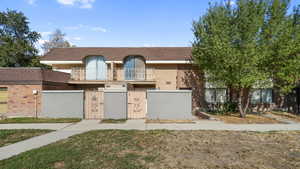 Back of townhome with gate into the back patio