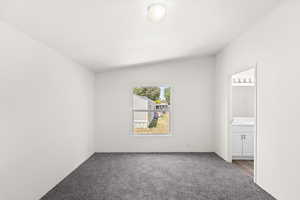 Unfurnished bedroom with carpet and connected bathroom