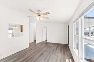 Unfurnished living room with light wood-type flooring, a chandelier, ceiling fan, and crown molding