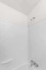 Bathroom with shower / bath combination and ornamental molding