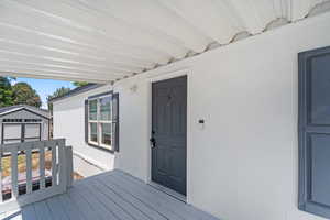 Wooden deck featuring a storage shed