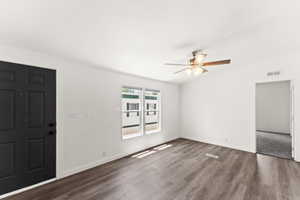 Foyer featuring dark wood-style flooring and a ceiling fan