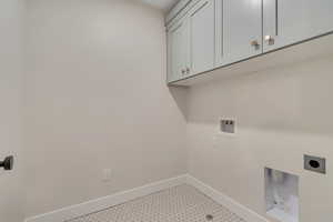 Laundry room featuring cabinet space, washer hookup, and hookup for an electric dryer