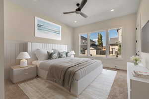 Bedroom with light carpet, ceiling fan, recessed lighting, and a wainscoted wall