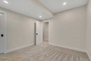 Unfurnished room featuring recessed lighting and light carpet