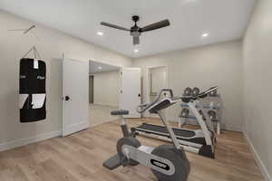 Workout room featuring recessed lighting, light wood-style floors, and a ceiling fan