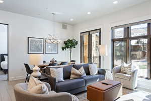 Living room featuring recessed lighting, wood finished floors, and a chandelier