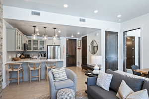 Living room with recessed lighting and light wood-style flooring