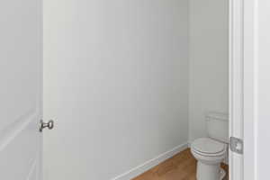 Bathroom with light wood-style floors and baseboards