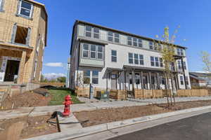 View of front of property featuring stucco siding and a fenced front yard