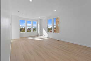 Spare room with light wood finished floors and recessed lighting
