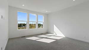 Unfurnished room with carpet flooring and recessed lighting