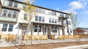Traditional-style house with stucco siding and covered porch