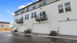Back of house featuring a balcony and stucco siding