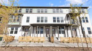 Traditional home featuring stucco siding and covered porch