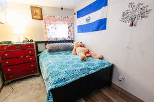 Bedroom featuring baseboards and wood finished floors