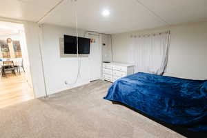Bedroom featuring light colored carpet and baseboards